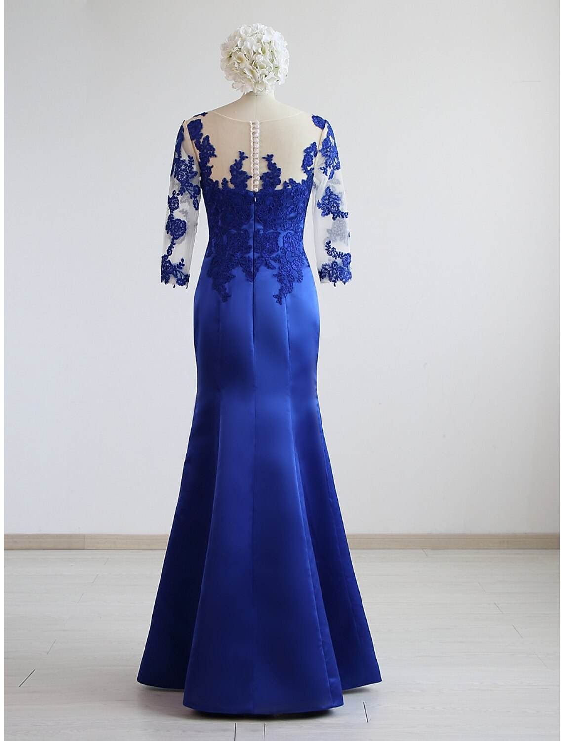 Side view of the navy blue pleated satin formal gown.