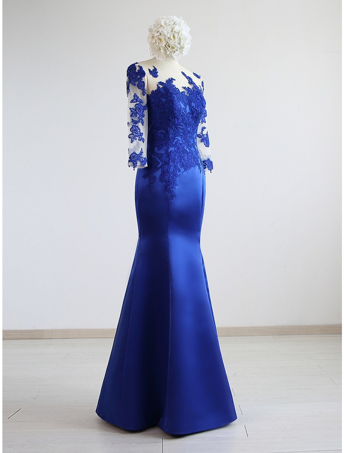 Detail of the pleated satin fabric on the navy blue formal dress.