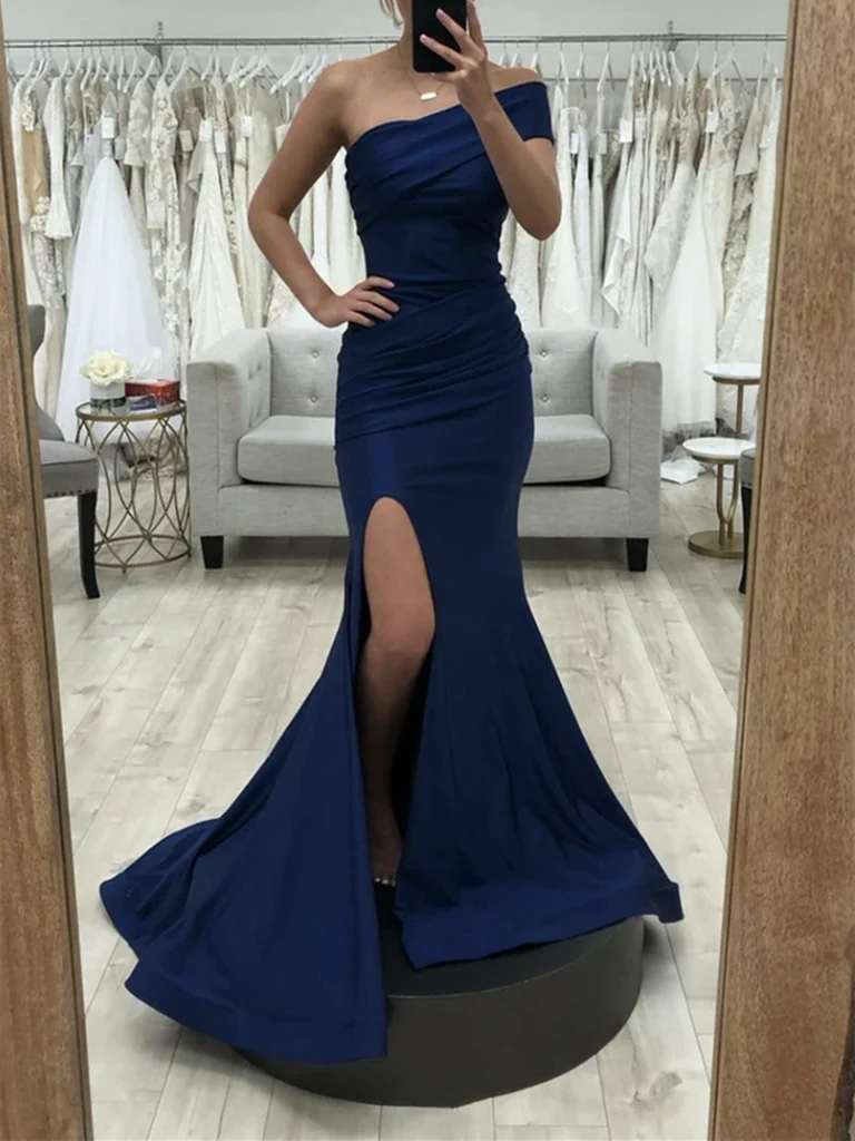Woman wearing an elegant navy blue V-neck mermaid long prom dress.