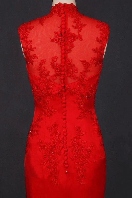 Close-up of appliques on the bodice of a navy high neck satin dress.