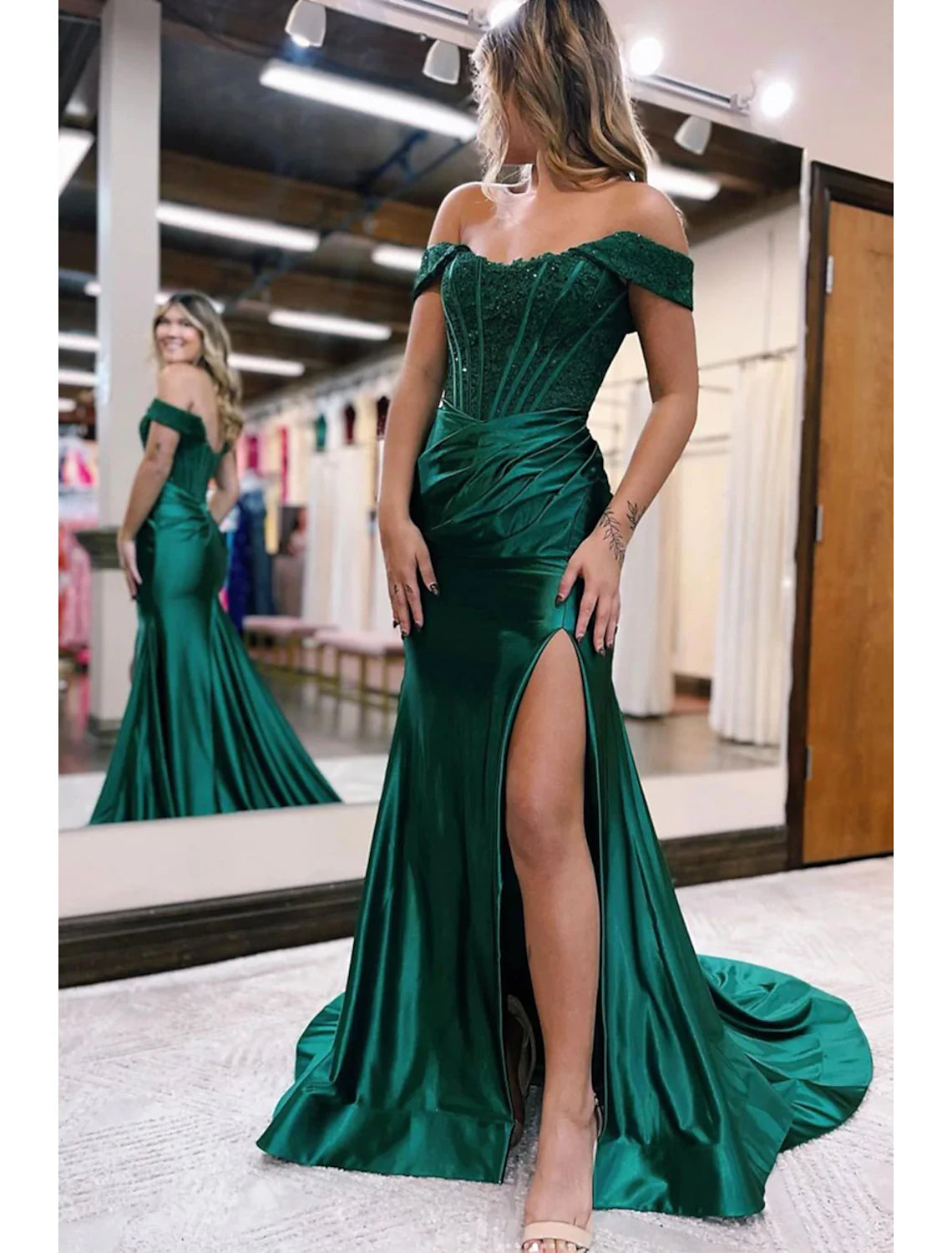 Elegant navy off-shoulder mermaid evening gown with a court train and slit.