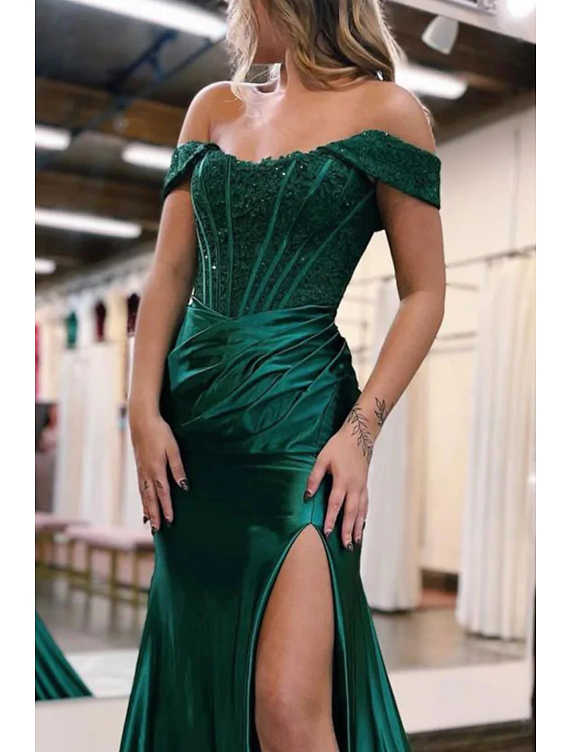 Navy off-shoulder mermaid gown, highlighting the imitation silk fabric and appliques.