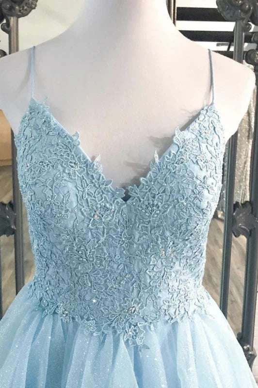 Close-up of shiny fabric and lace detail on a V-neck prom dress.