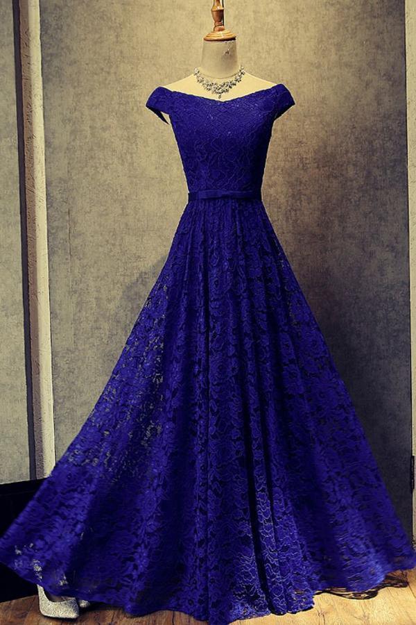 Elegant off-shoulder floor length prom dress in a formal setting.