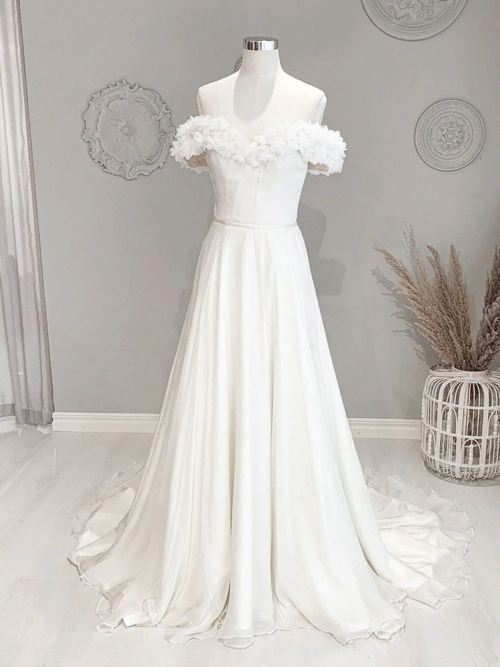 White off-shoulder floral long beach wedding dress, front view.