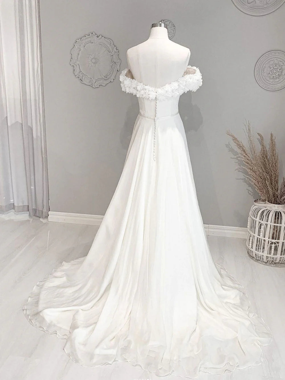 Back view of a white off-shoulder floral long beach wedding dress.