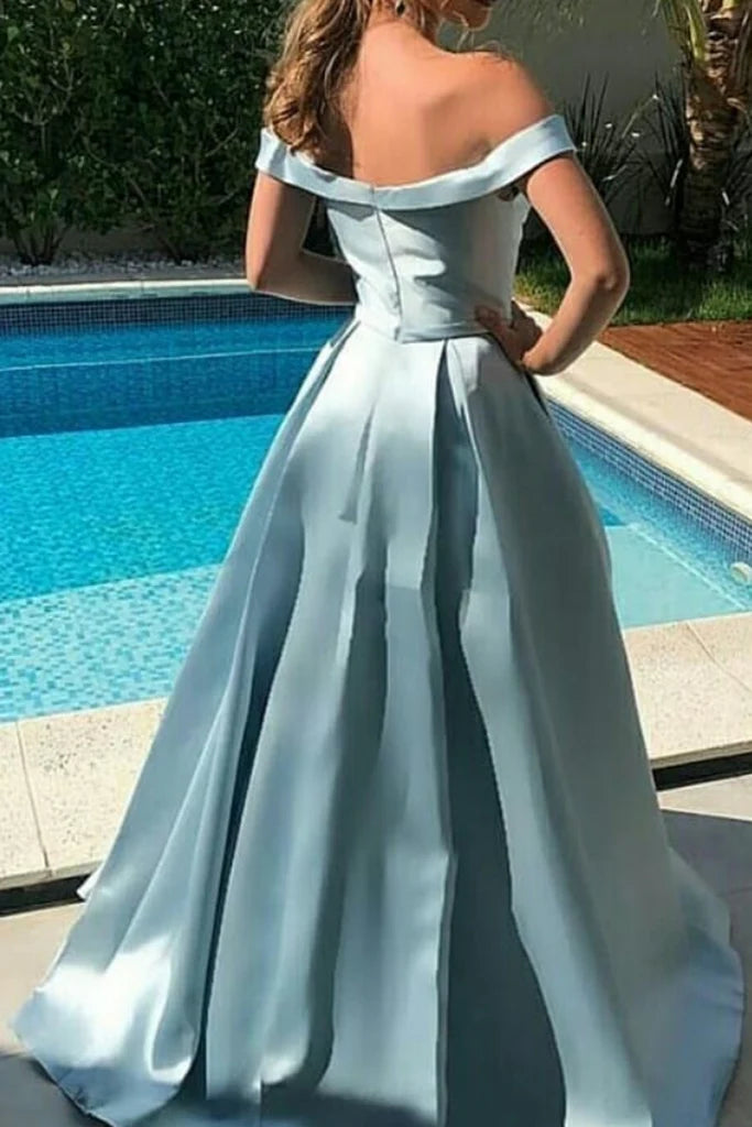 Woman wearing a sophisticated off-shoulder evening gown.