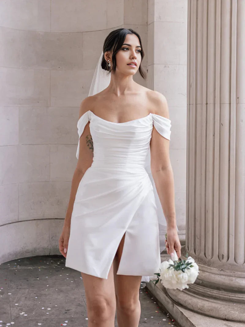 Model posing in the short off-shoulder satin dress, side view.