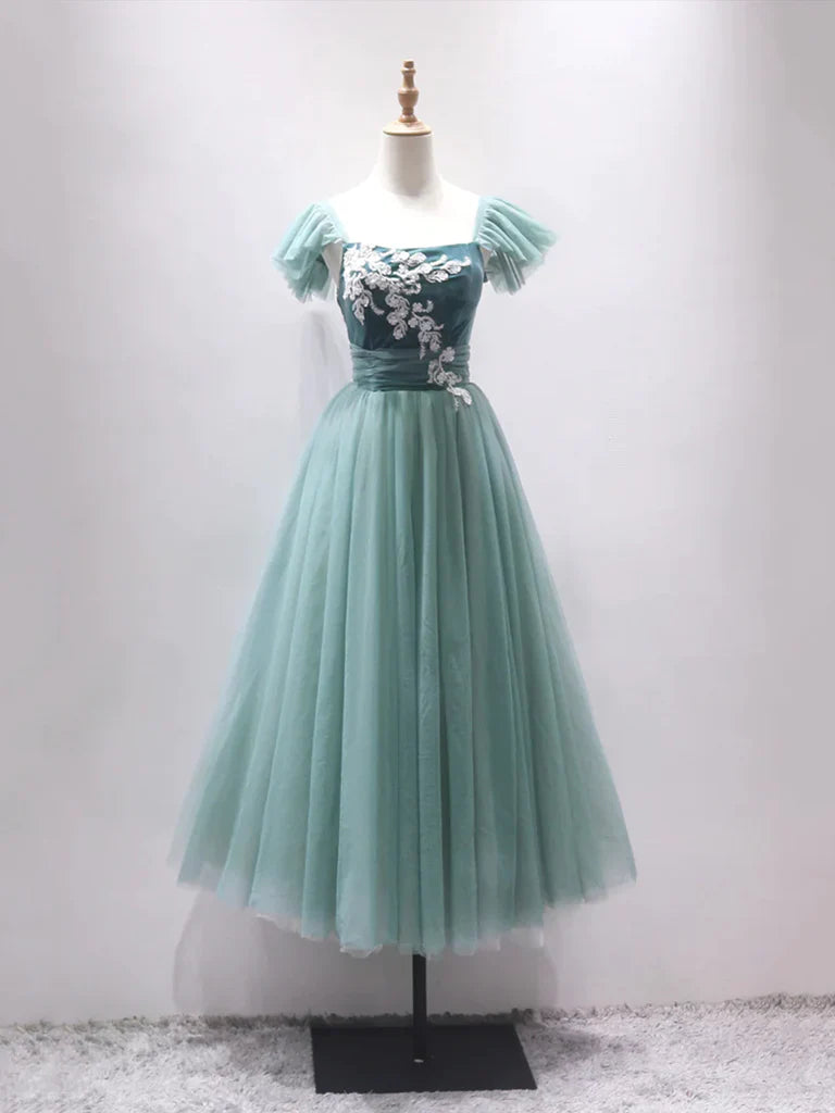 Model wearing an elegant off-shoulder A-line tulle tea length prom dress.
