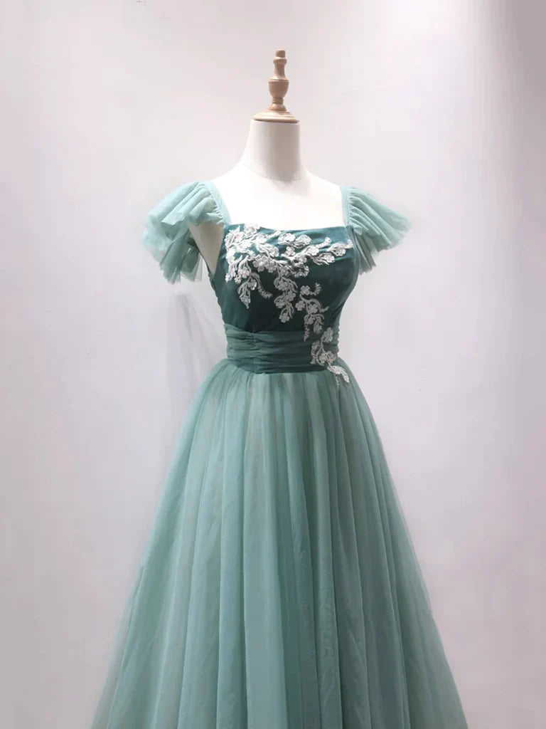Close-up of the delicate tulle fabric and off-shoulder neckline of the prom dress.