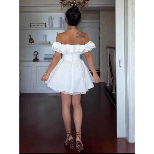 Back view of white off-shoulder lace mini dress.
