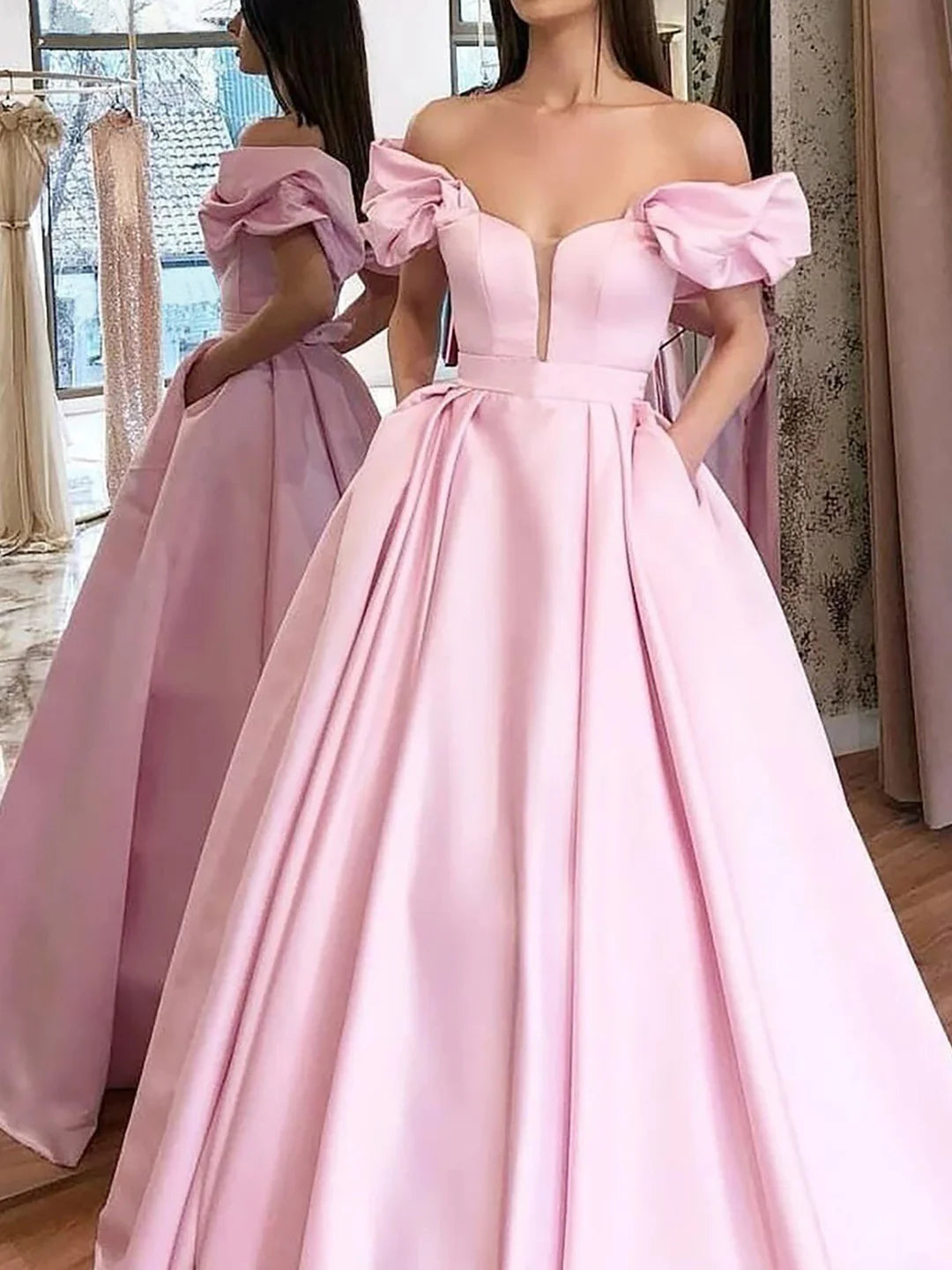 Full view of an off-shoulder formal ball gown dress, showcasing its floor-length design.
