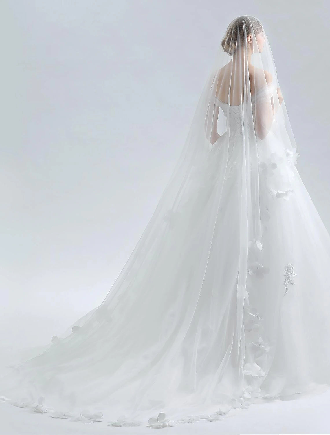 Back view of the off-shoulder ball gown wedding dress showing cathedral train.