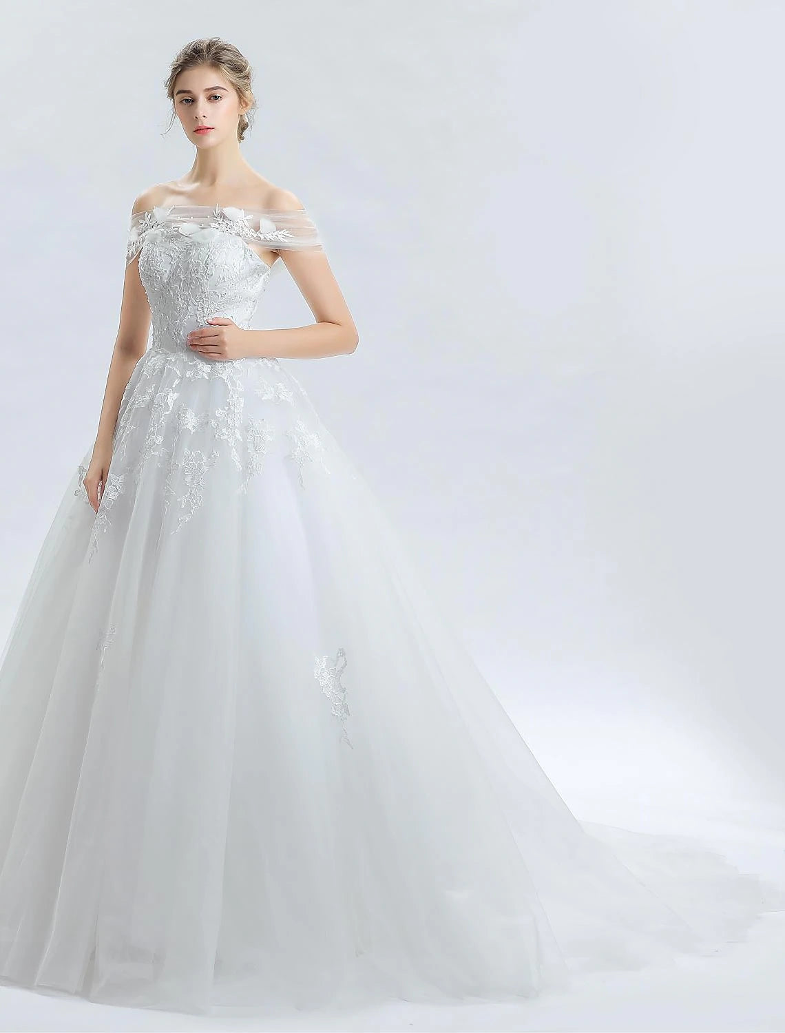 Close-up of delicate lace beading on the off-shoulder satin wedding dress.
