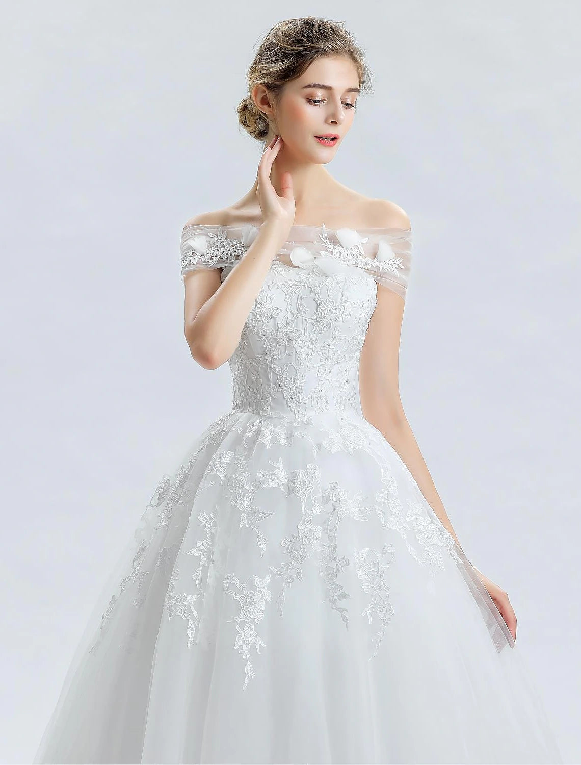 Front view of the off-shoulder satin bridal gown with elegant neckline.