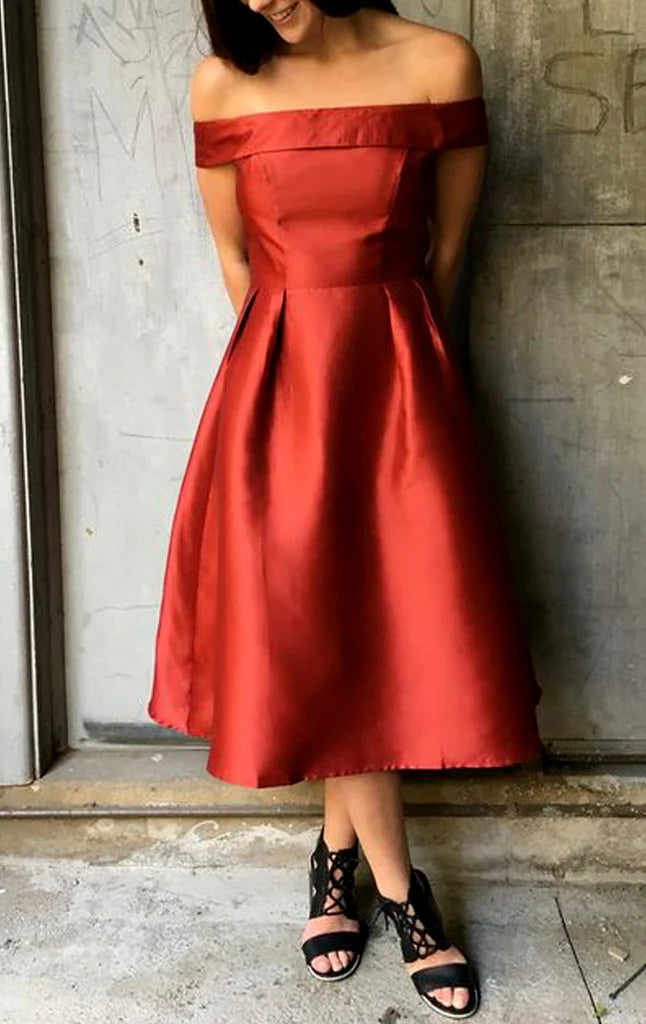 Model wearing an elegant off-shoulder Bardot prom gown.