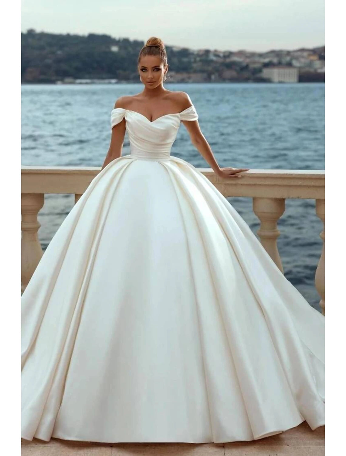 Elegant off-shoulder satin ball gown wedding dress with cap sleeves and court train.