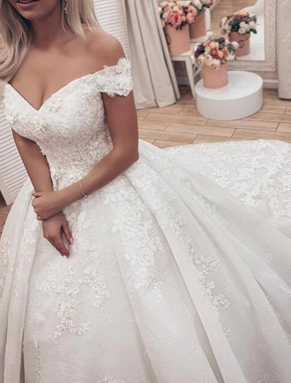 Back view of the bridal ball gown showing chapel train and lace details.