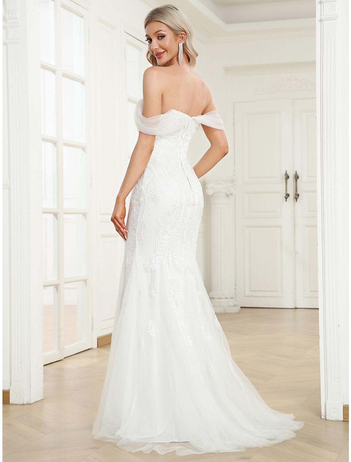 Side view of the mermaid trumpet bridal gown with sweep train.