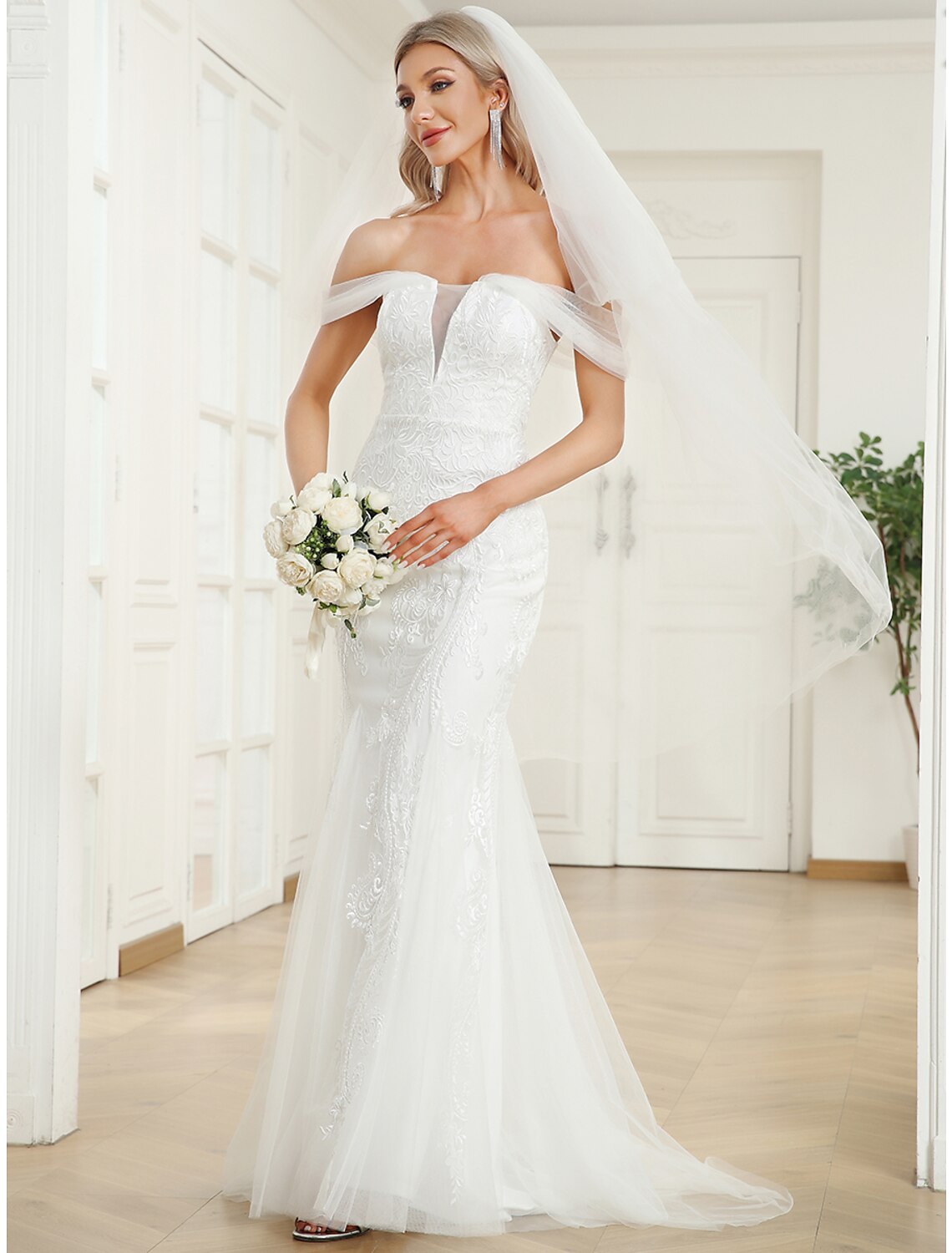 Close-up of lace appliques on the wedding dress bodice.