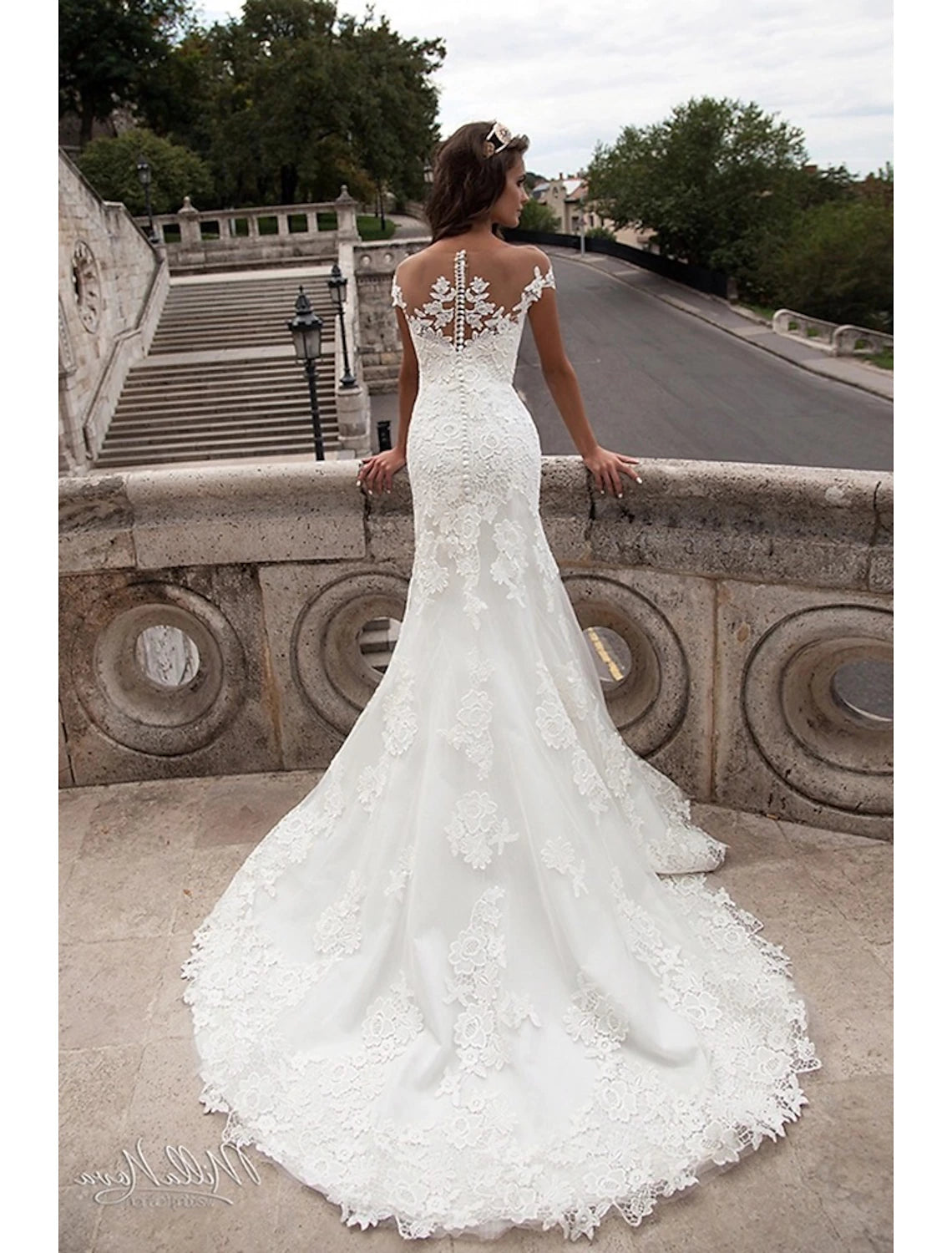 Back view of the mermaid wedding dress showing open back and court train.