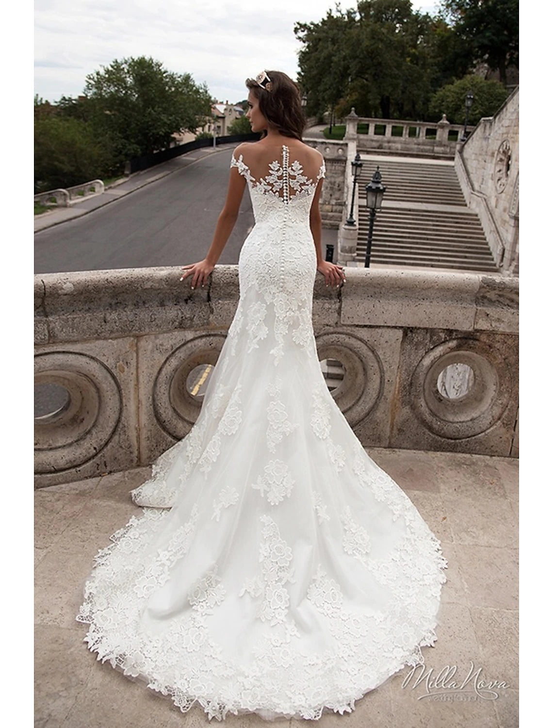 Side profile of the mermaid trumpet wedding dress with cap sleeves.