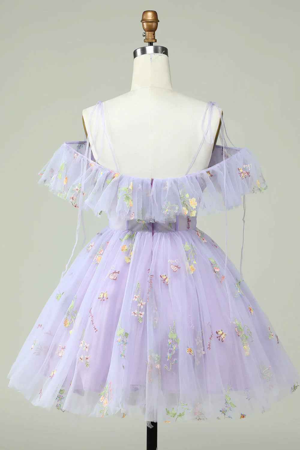 Side view of a woman in a lavender off-shoulder corset prom dress with ruffles.