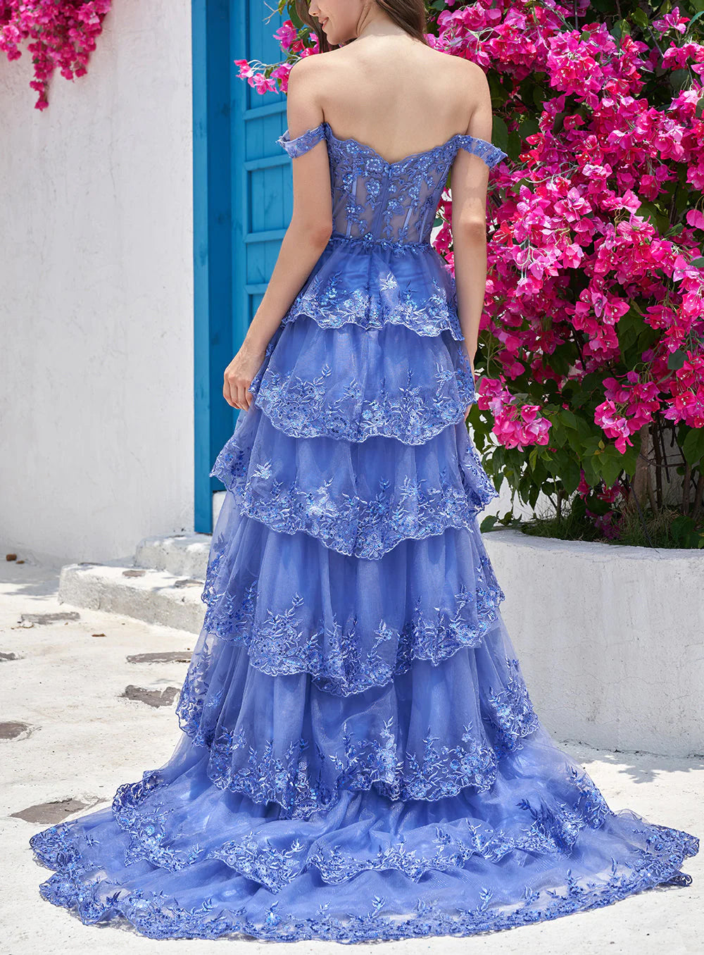 Close-up of the dark blue tiered dress showing corset detail and fabric texture.