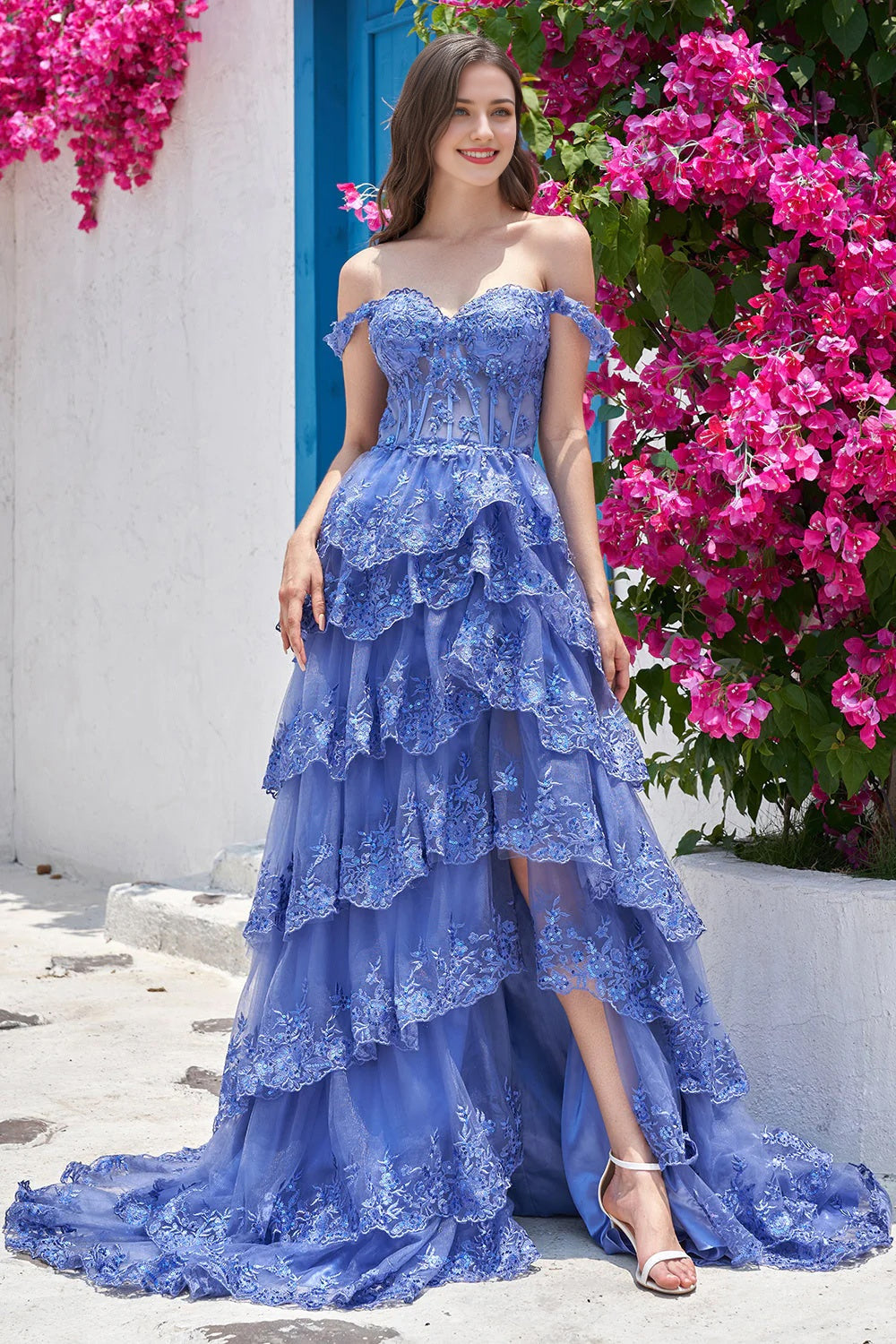 Full length view of the dark blue formal dress, highlighting the slit and tiered design.