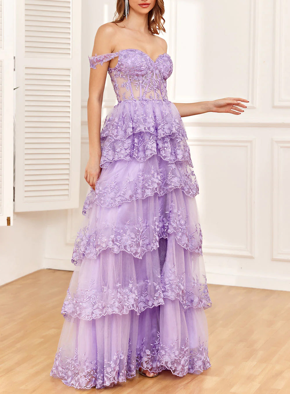 Model posing in the formal dress, showing its silhouette and design details.