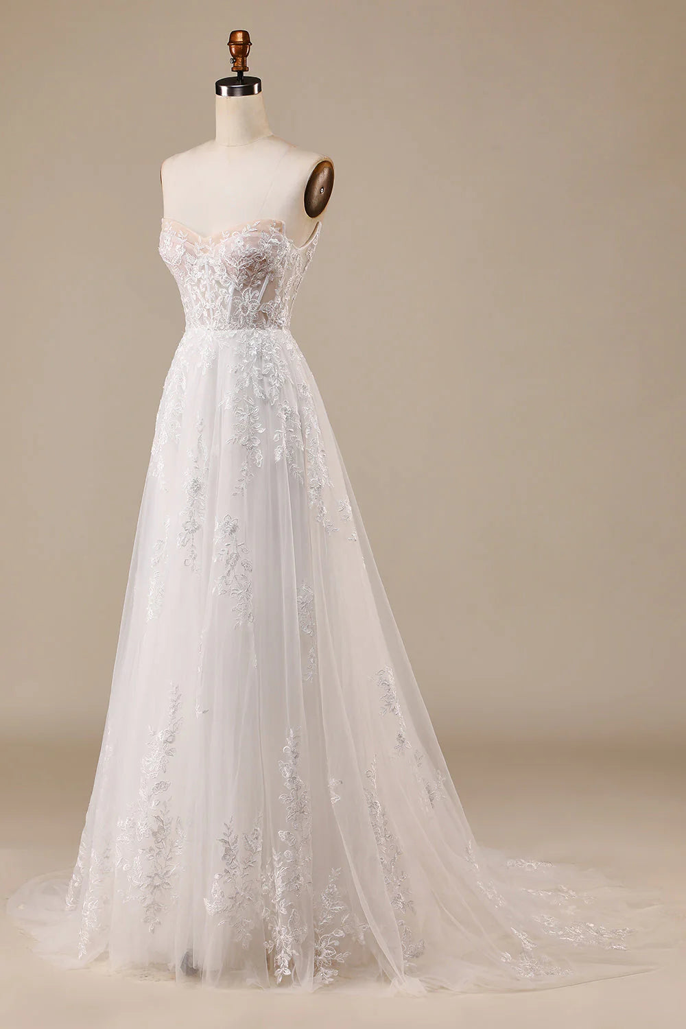 Back view of an ivory off-shoulder wedding dress with a long tulle train.