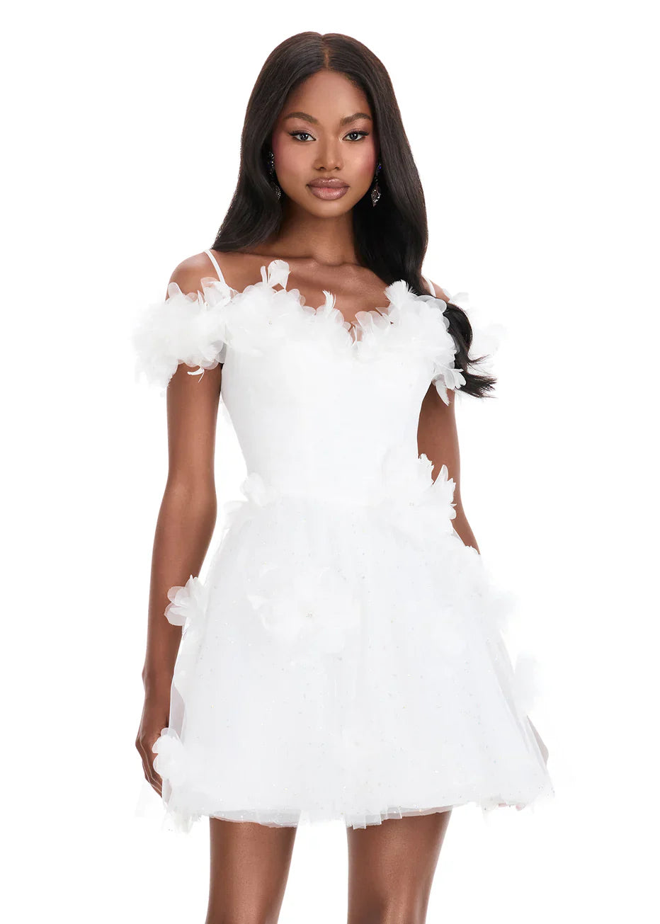 Close-up of the floral applique and off-shoulder neckline on the white dress.
