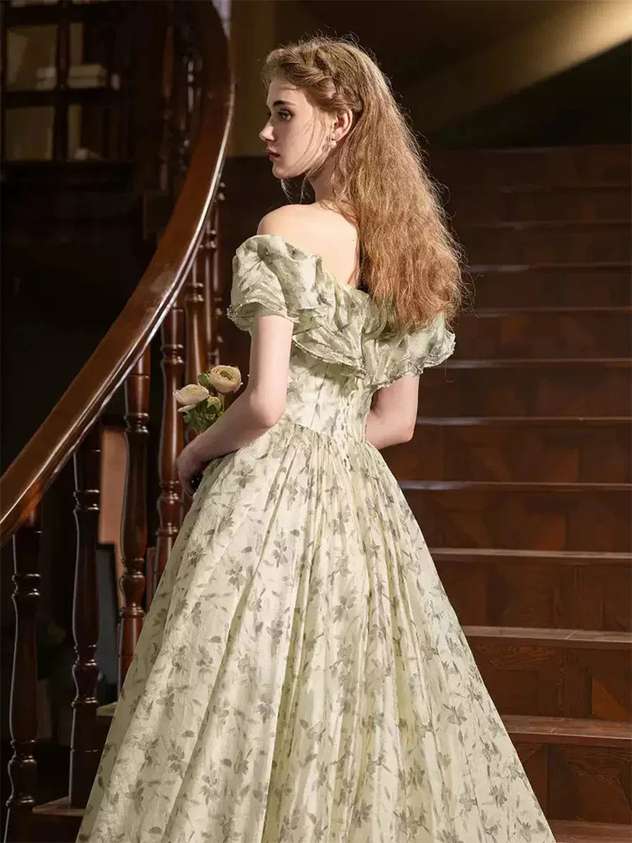 Side view of sage floral brocade gown with ruffled off-shoulder neckline.