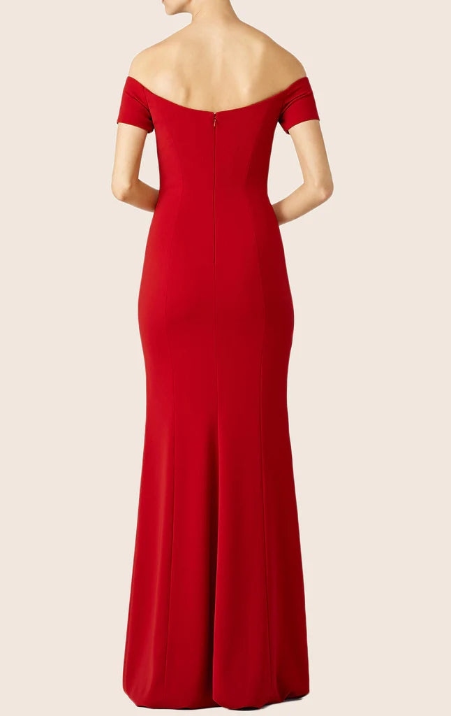 Back view of a woman wearing an off-shoulder maxi prom dress.