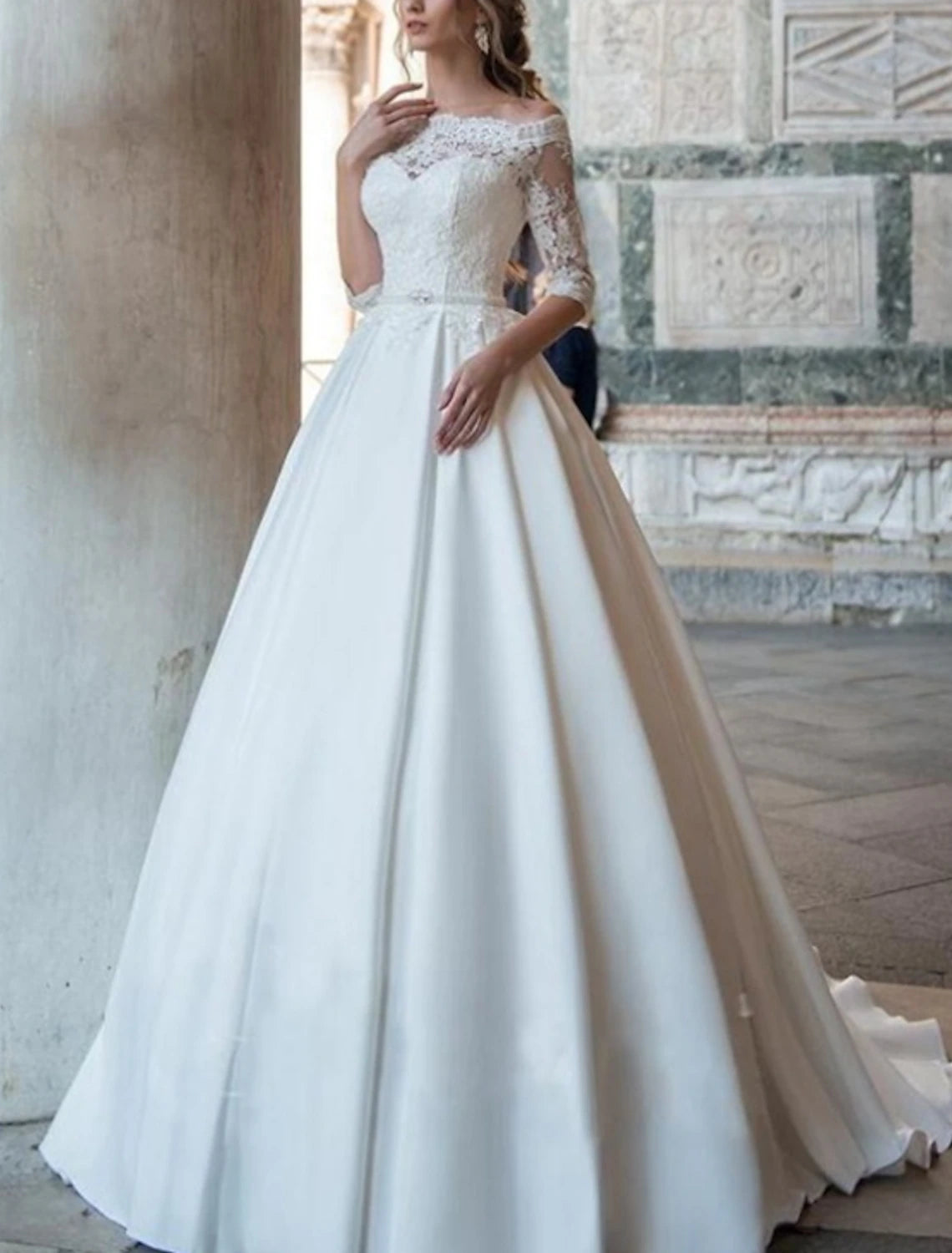 Side view of the bridal ball gown, highlighting the off-shoulder neckline and half sleeves.