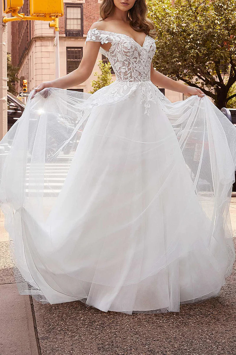 Elegant off-shoulder wedding dress with lace appliques.