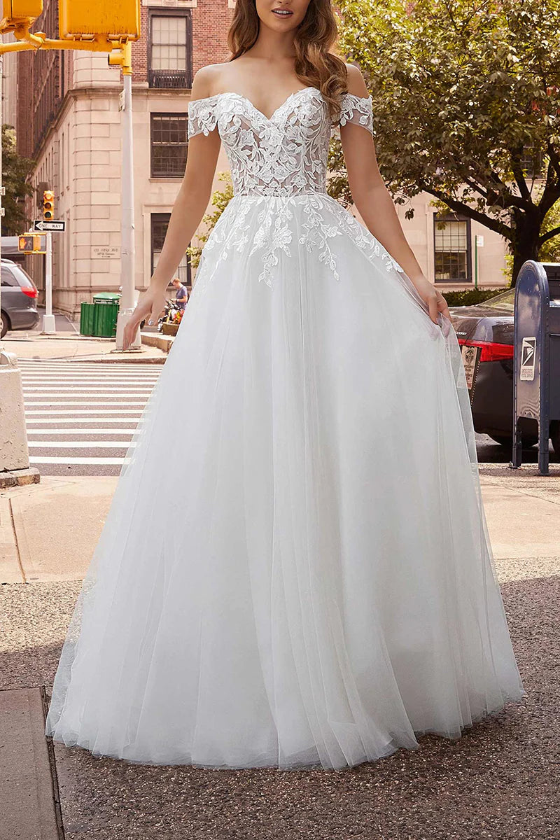 Bride wearing an off-shoulder ankle-length wedding dress.