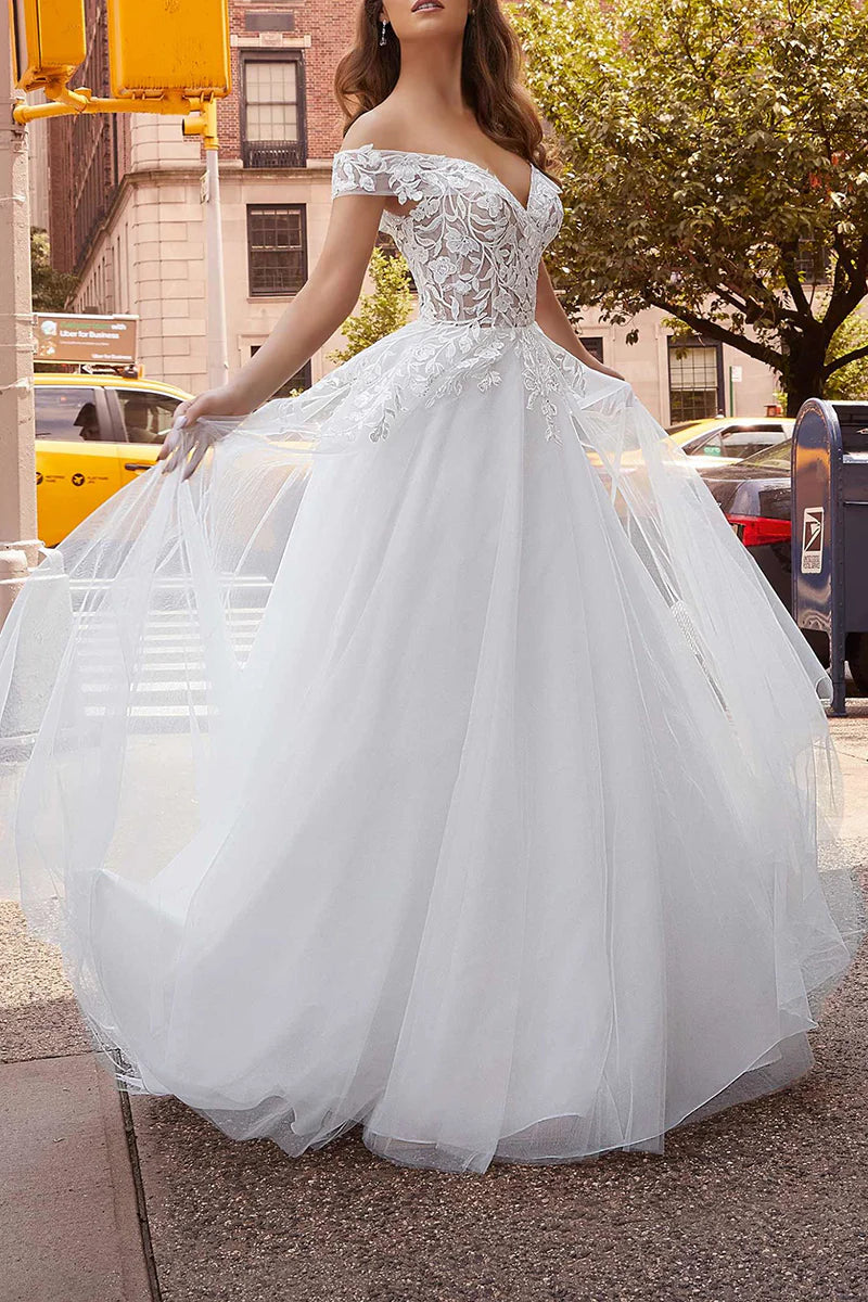 Side profile of the elegant off-shoulder bridal gown.