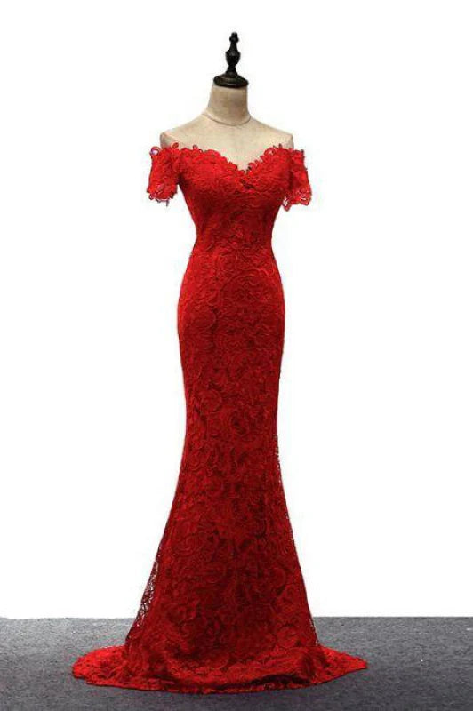 Woman posing in a long off-shoulder mermaid evening gown.