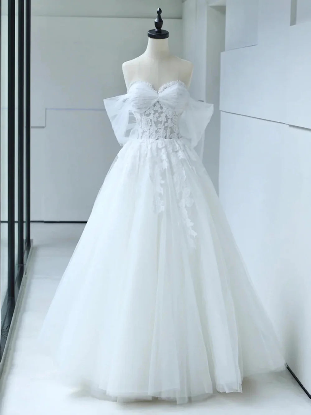 White off-shoulder lace mermaid wedding dress.