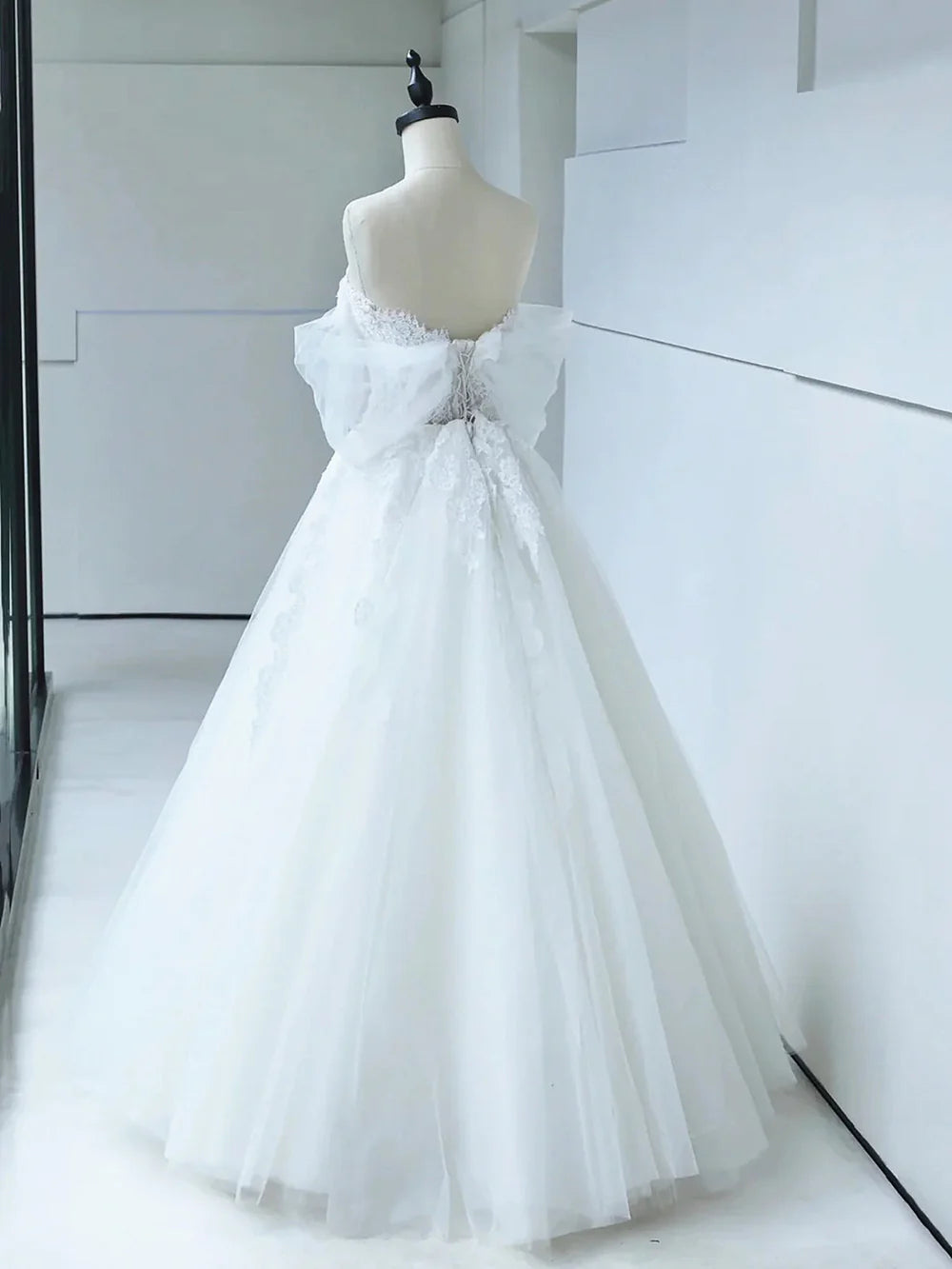 Close-up of lace detail on off-shoulder bridal gown.
