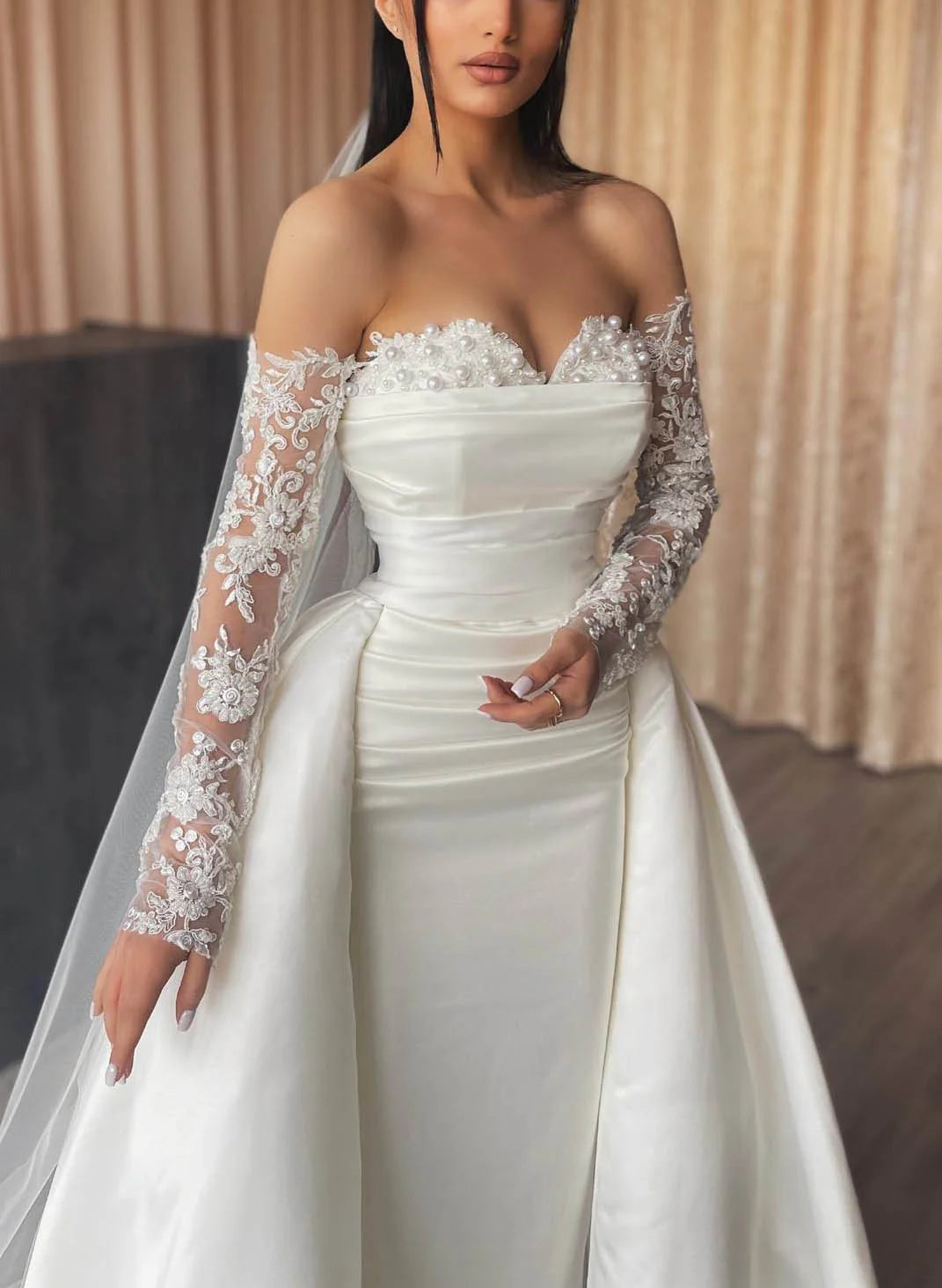Close-up of the off-shoulder neckline and lace bodice details.