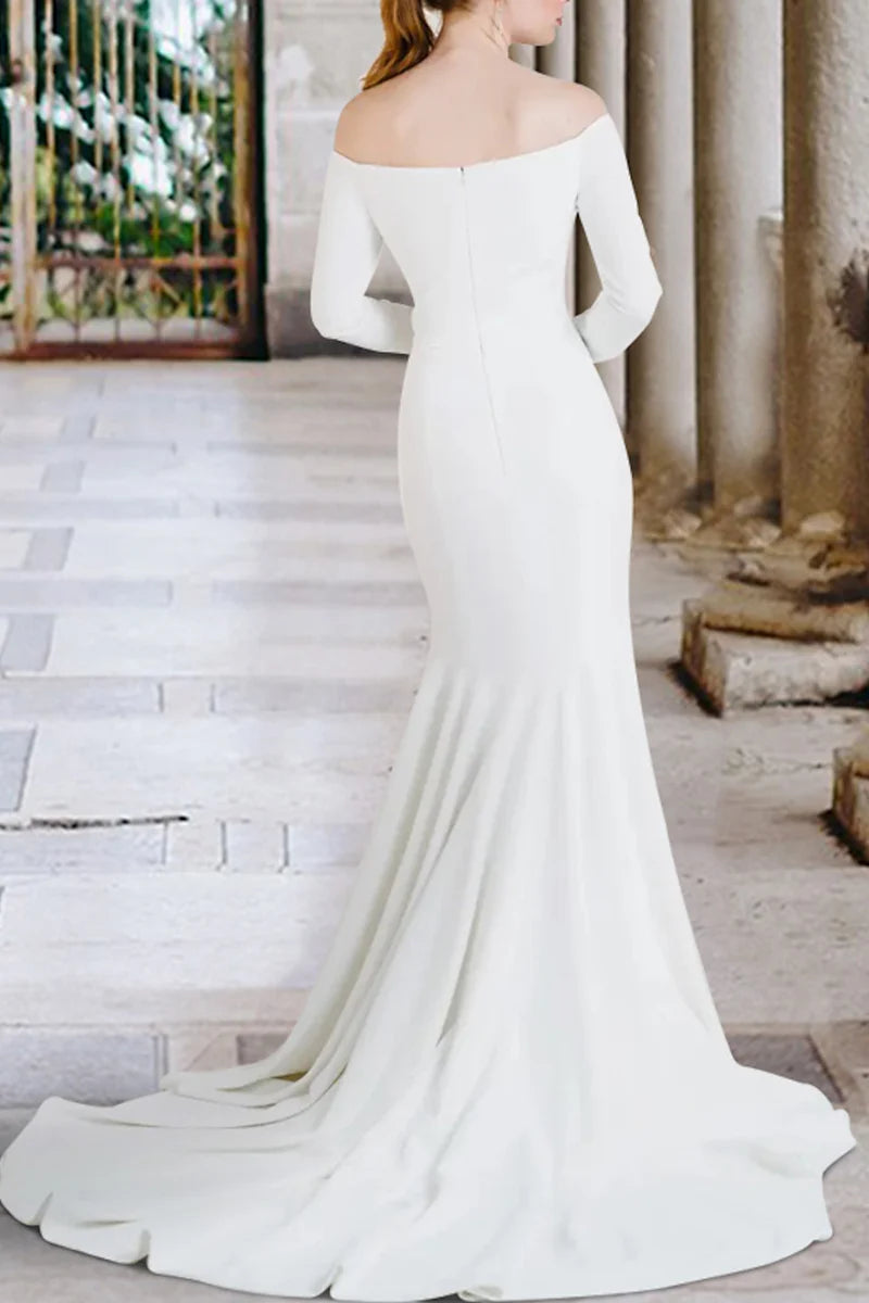 Simple white off-shoulder wedding dress, full length view.