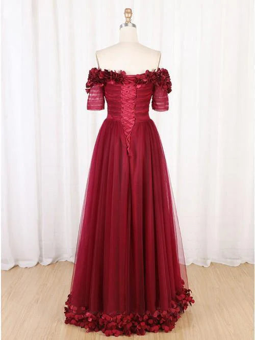 Model in a sophisticated off-shoulder long formal gown, side profile.