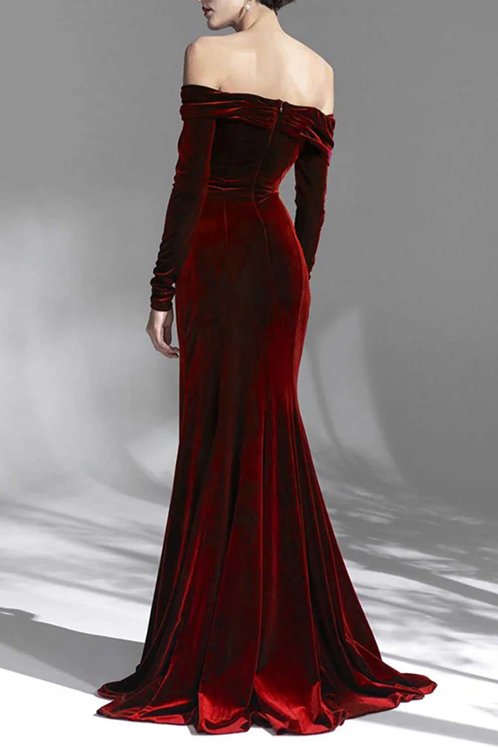 Back view of a woman in a burgundy off-shoulder long sleeve formal gown, showcasing the flowing skirt.