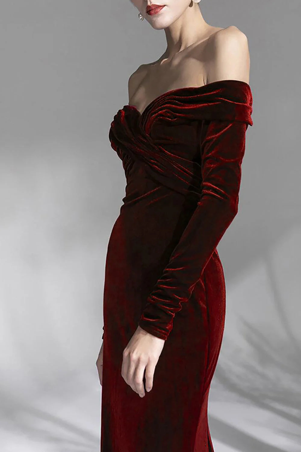 Close-up of the bodice and off-shoulder detail of a burgundy long sleeve prom dress.