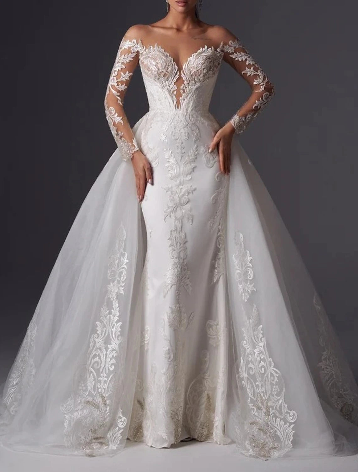 Back view of a white satin mermaid wedding dress featuring a court train and delicate appliques.