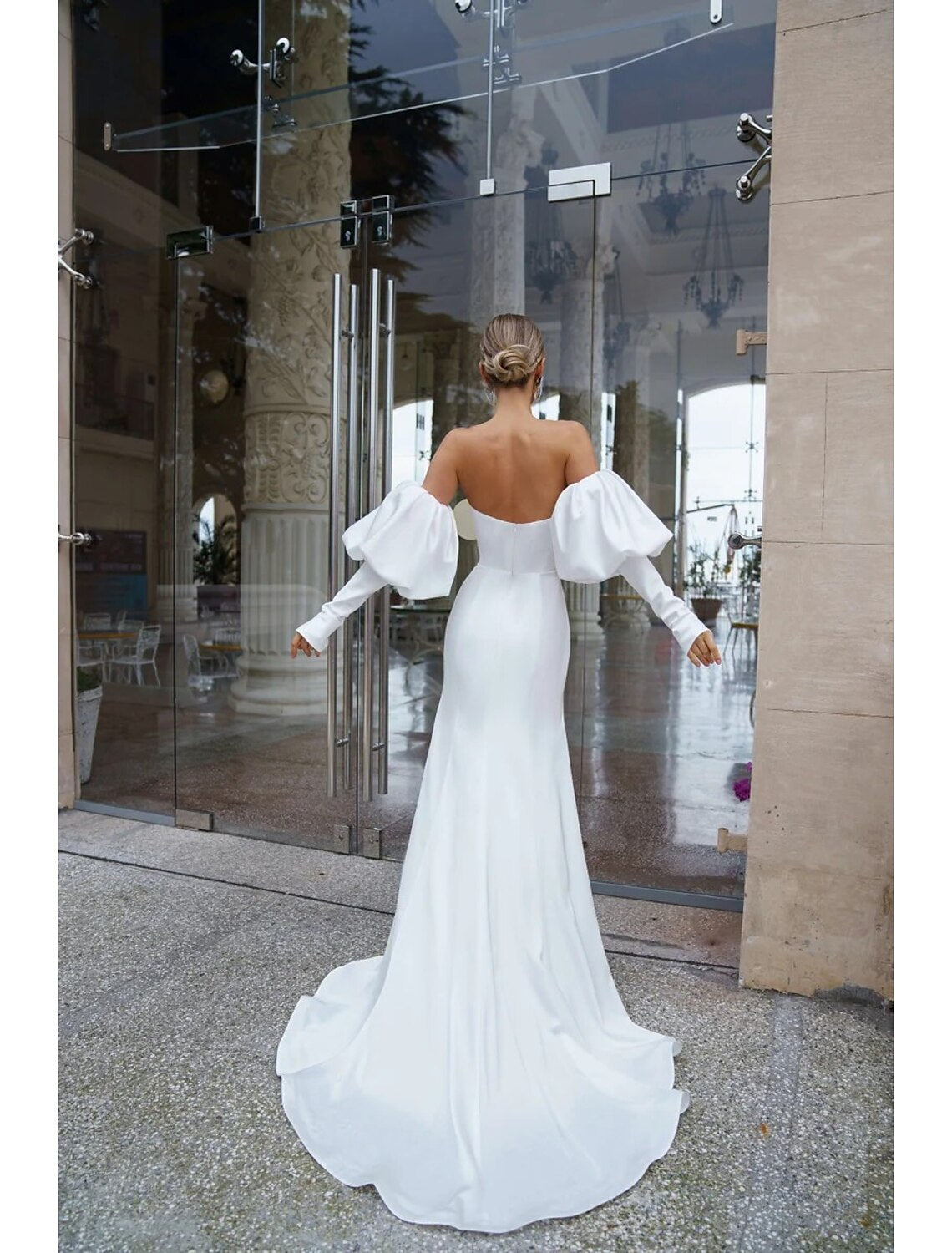 Back view of the off-shoulder long sleeve satin mermaid wedding dress, showcasing the court train.