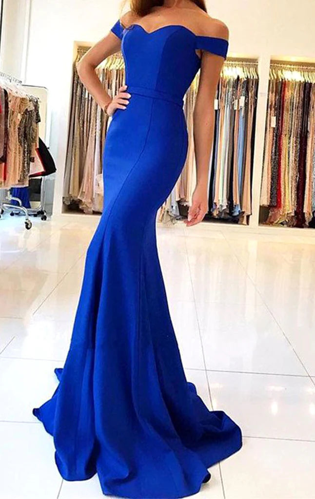 Woman wearing an elegant off-shoulder mermaid prom dress in a formal setting.