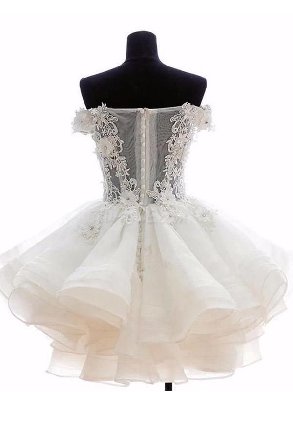 Close-up of a pink off-shoulder organza short dress with ruffled details.